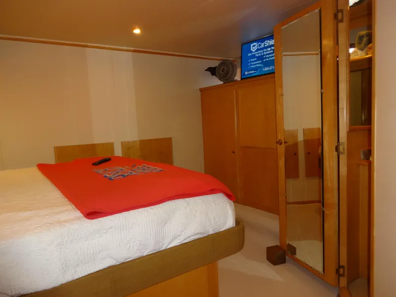 Slide: The Image of Cozy bedroom interior of 1998 Navigator 53 Classic yacht with wooden cabinets and mirrored door. - 37