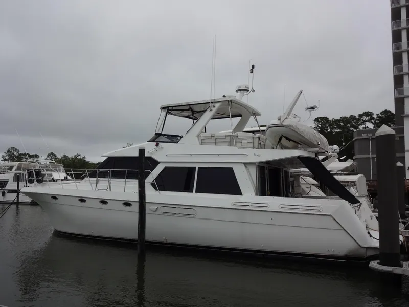 Slide: The Image of 1998 Navigator 53 Classic yacht docked at marina under cloudy skies. - 4