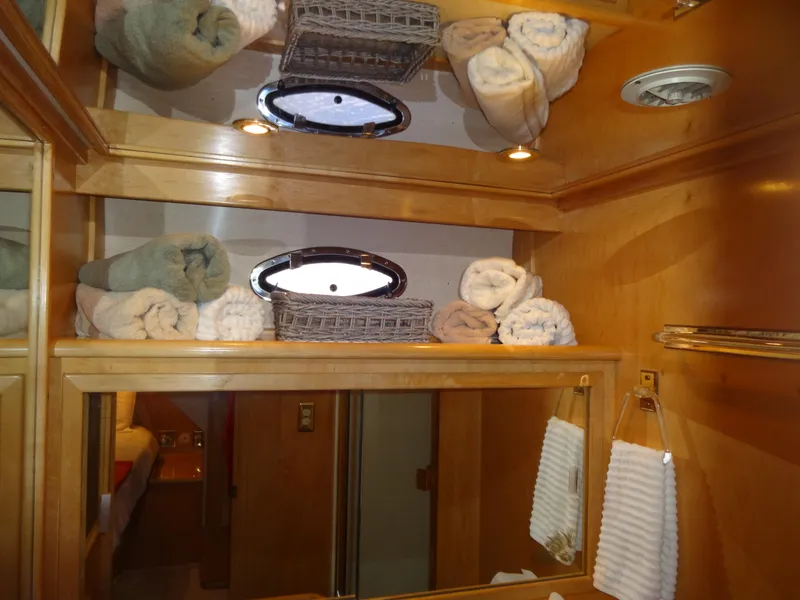 Slide: The Image of Luxurious bathroom interior of 1998 Navigator 53 Classic yacht with rolled towels and wooden cabinetry. - 49