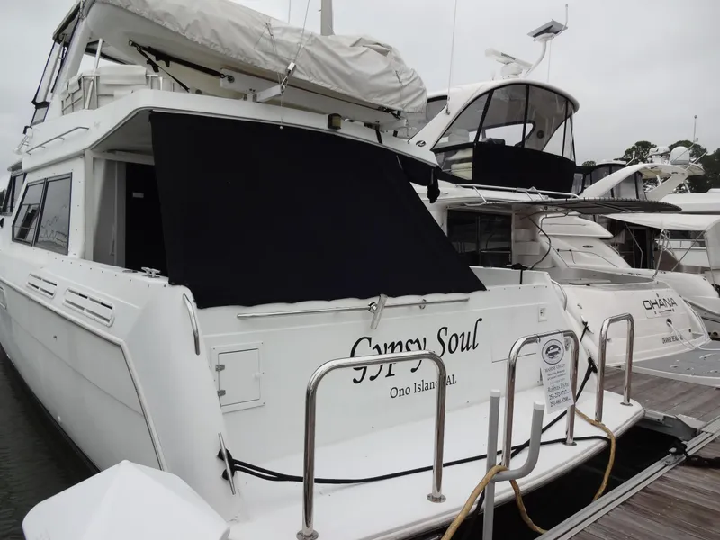 Slide: The Image of 1998 Navigator 53 Classic yacht docked, named "Gypsy Soul," with covered windows. - 5