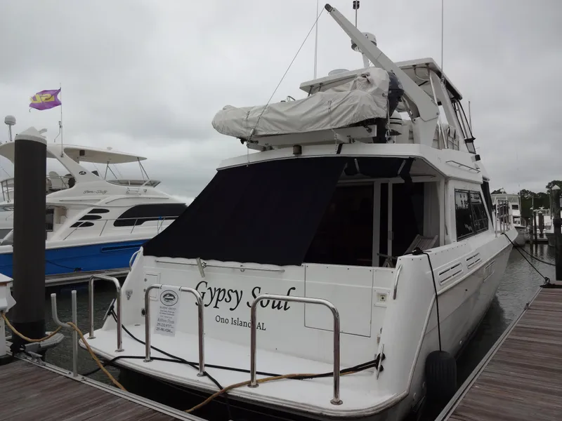 Slide: The Image of 1998 Navigator 53 Classic yacht docked at marina, overcast sky, rear view. - 6