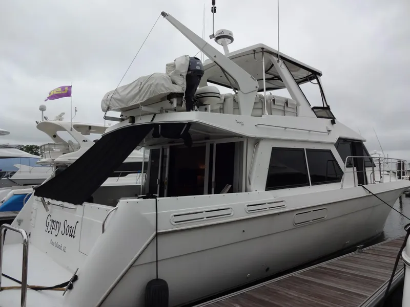 Slide: The Image of 1998 Navigator 53 Classic yacht docked, featuring sleek design and spacious upper deck. - 7