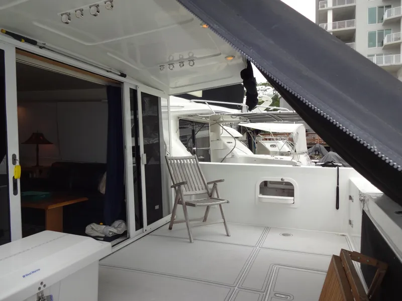 Slide: The Image of 1998 Navigator 53 Classic yacht deck with seating and marina view. - 9