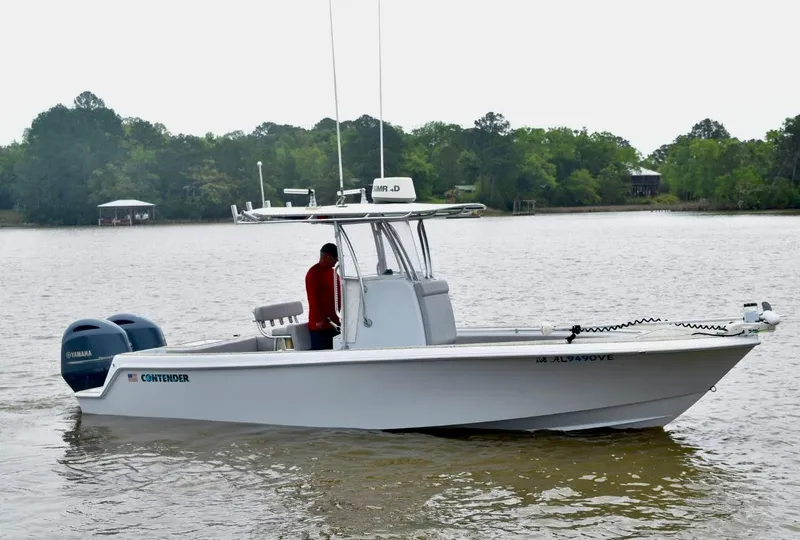 Slide: The Image of 2018 Contender 25T boat on a lake with dual Yamaha engines. - 1