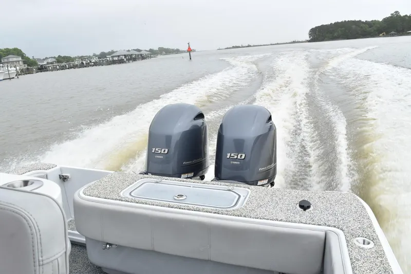 Slide: The Image of 2018 Contender 25T boat with twin 150 horsepower engines cruising on a river. - 11