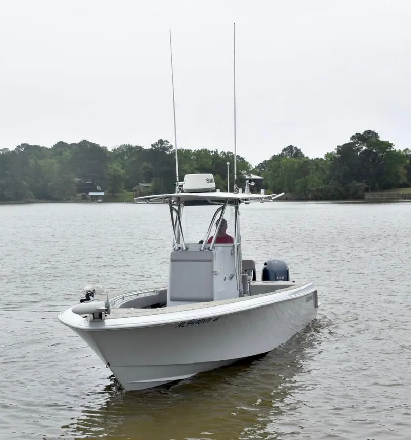 Slide: The Image of 2018 Contender 25T boat on calm lake with trees in background. - 3