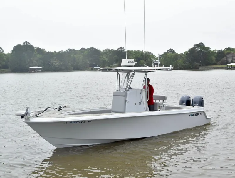 Slide: The Image of 2018 Contender 25T boat on calm lake with trees in background. - 4