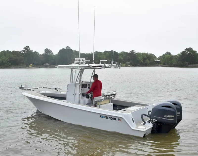 Slide: The Image of 2018 Contender 25T boat with dual Yamaha engines on a calm lake. - 7