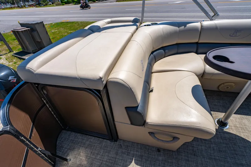 Slide: The Image of 2016 Misty Harbor 2285CS Biscayne Bay pontoon boat with beige seating and table. - 11