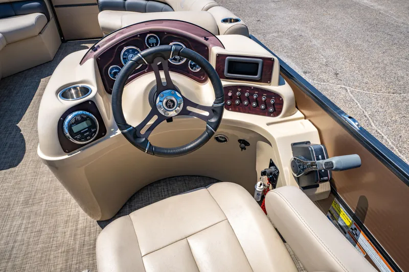 Slide: The Image of 2016 Misty Harbor 2285CS Biscayne Bay boat dashboard with steering wheel and controls. - 13