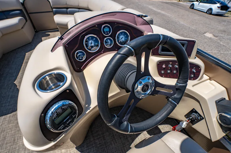Slide: The Image of 2016 Misty Harbor 2285CS Biscayne Bay boat dashboard with steering wheel and gauges. - 14