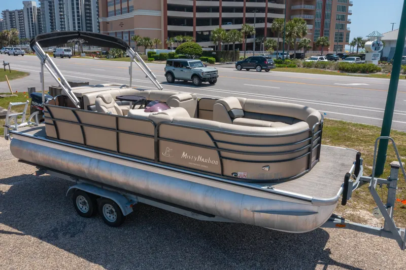 Slide: The Image of 2016 Misty Harbor 2285CS Biscayne Bay pontoon boat on trailer, parked near a road. - 15