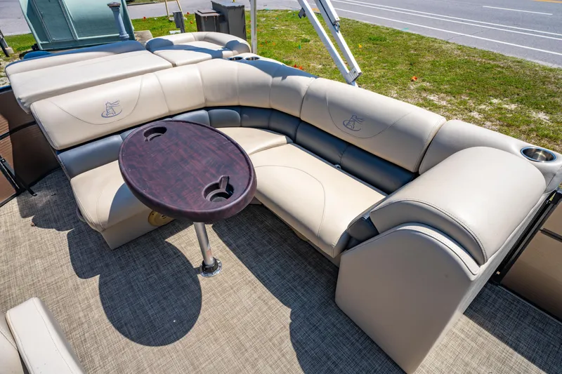 Slide: The Image of 2016 Misty Harbor 2285CS Biscayne Bay boat interior with beige seating and round table. - 9