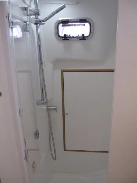 Slide: The Image of 2025 Jeanneau Sun Odyssey 350 yacht bathroom with shower and porthole window. - 16