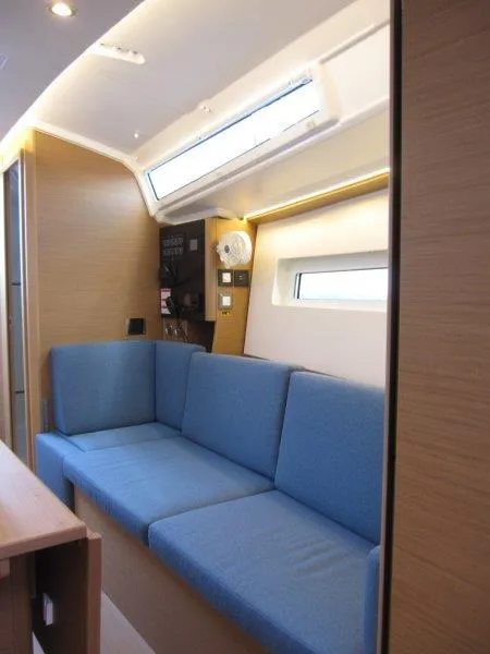 Slide: The Image of Interior of 2025 Jeanneau Sun Odyssey 350 yacht with blue seating and modern design. - 3