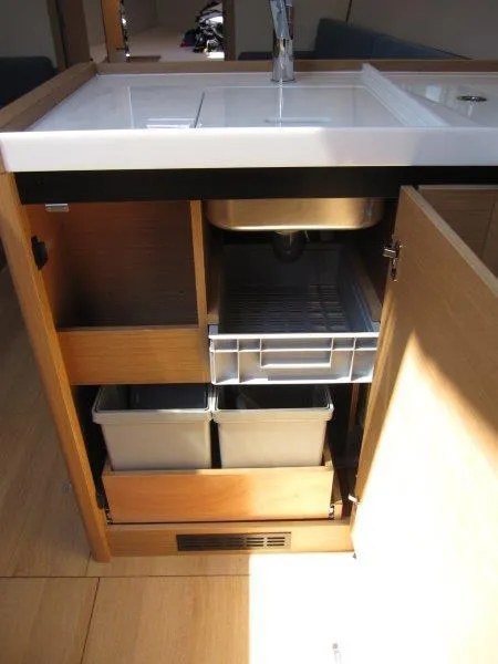 Slide: The Image of 2025 Jeanneau Sun Odyssey 350 yacht kitchen with sink, storage, and modern cabinetry. - 39