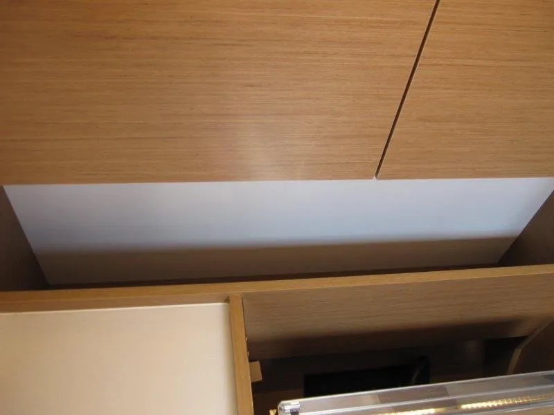 Slide: The Image of Interior cabinetry of 2025 Jeanneau Sun Odyssey 350 yacht, featuring sleek wooden design. - 45