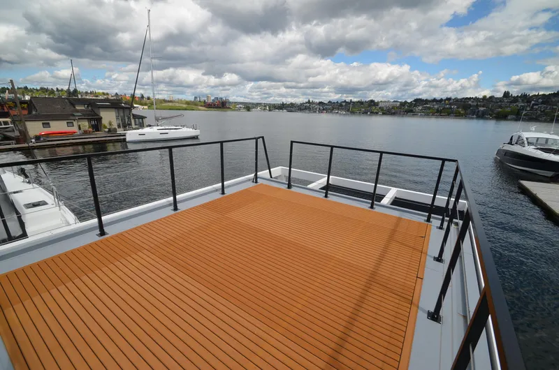 Slide: The Image of Rooftop deck of 2024 La Mare Modern 11 houseboat overlooking serene lake and marina. - 33