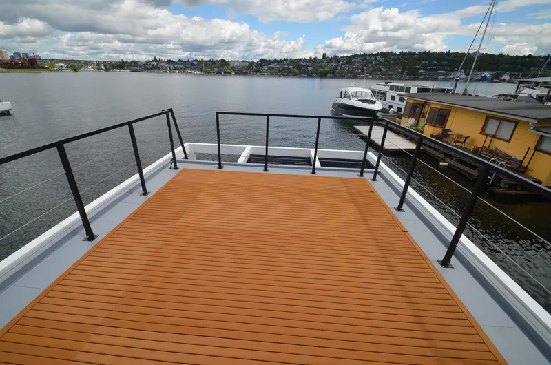 Slide: The Image of Rooftop deck of 2024 La Mare Modern 11 houseboat overlooking a serene lake. - 34