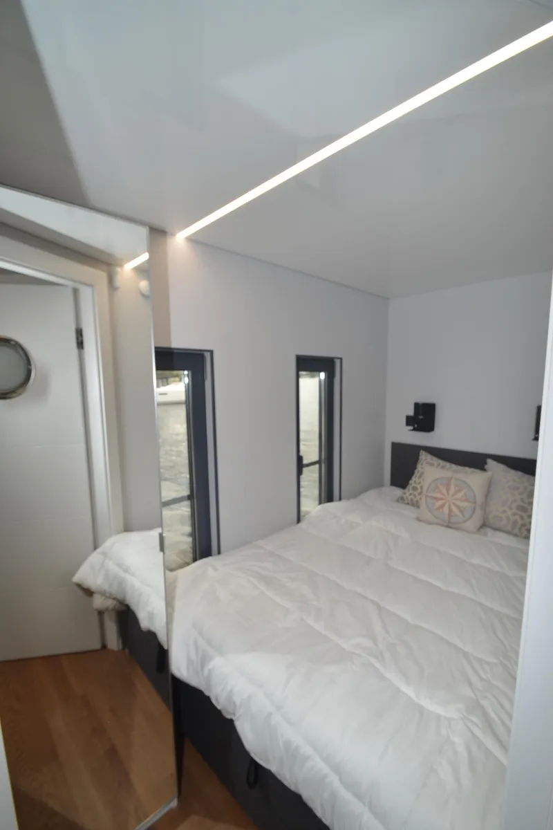 Slide: The Image of Compact bedroom in 2024 La Mare Modern 11 houseboat with cozy bed and minimalist decor. - 26