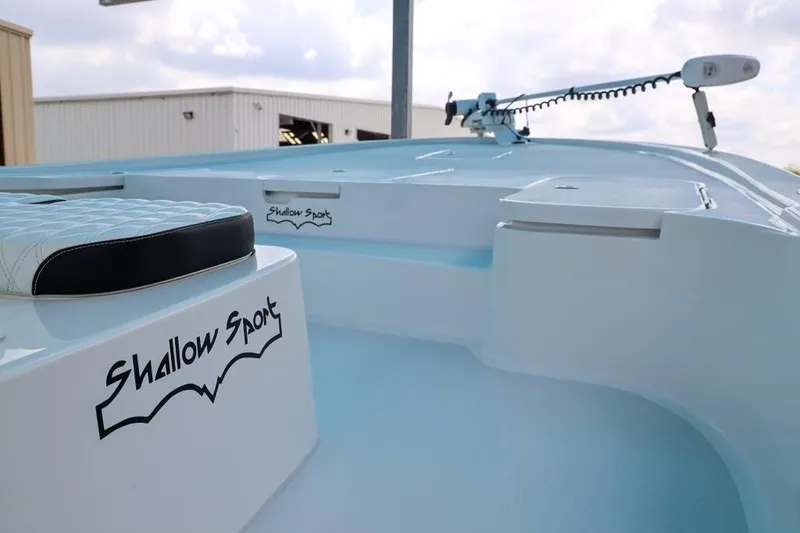 Slide: The Image of 2023 Shallow Sport 28 X3 boat interior with logo and seating detail. - 14