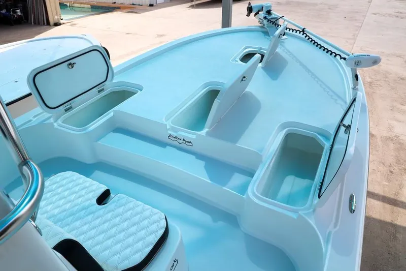 Slide: The Image of 2023 Shallow Sport 28 X3 boat interior with storage compartments and seating. - 16