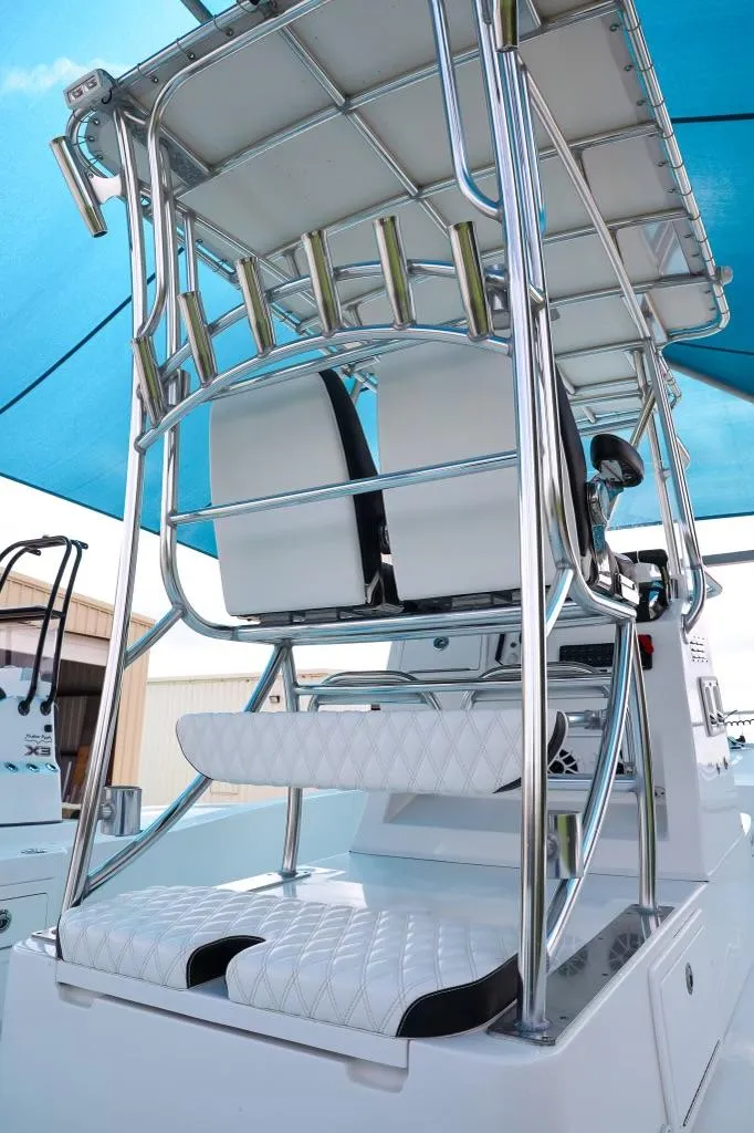 Slide: The Image of 2023 Shallow Sport 28 X3 boat with elevated seating and sleek design under a blue canopy. - 21