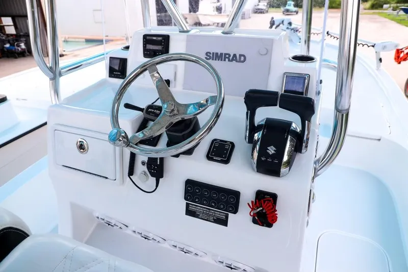 Slide: The Image of 2023 Shallow Sport 28 X3 boat console with steering wheel and controls. - 22
