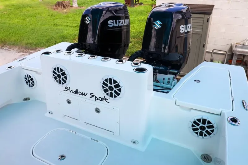 Slide: The Image of 2023 Shallow Sport 28 X3 boat with dual Suzuki outboard motors and speaker system. - 23