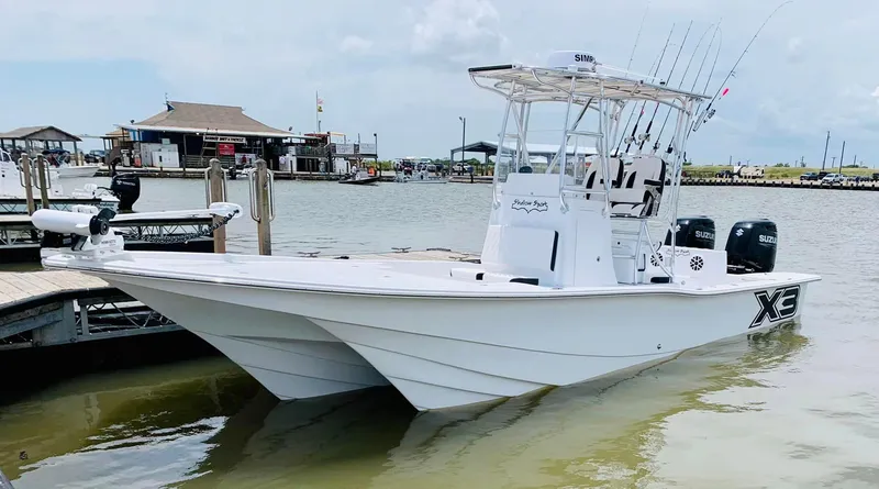 Slide: The Image of 2023 Shallow Sport 28 X3 boat docked at marina, featuring sleek design and fishing equipment. - 25
