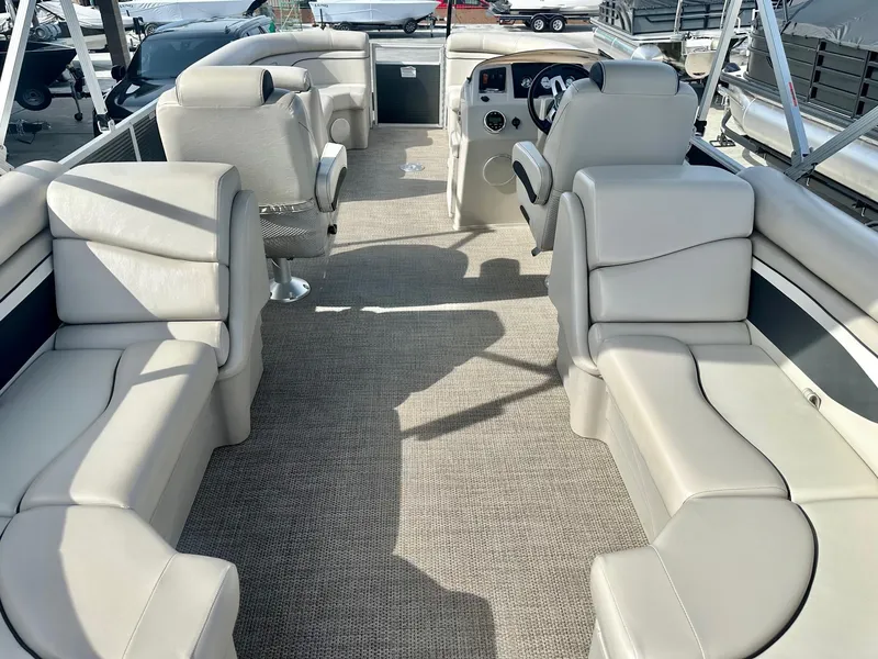 Slide: The Image of 2019 Bennington 22 SSX boat interior with plush seating and modern dashboard. - 17