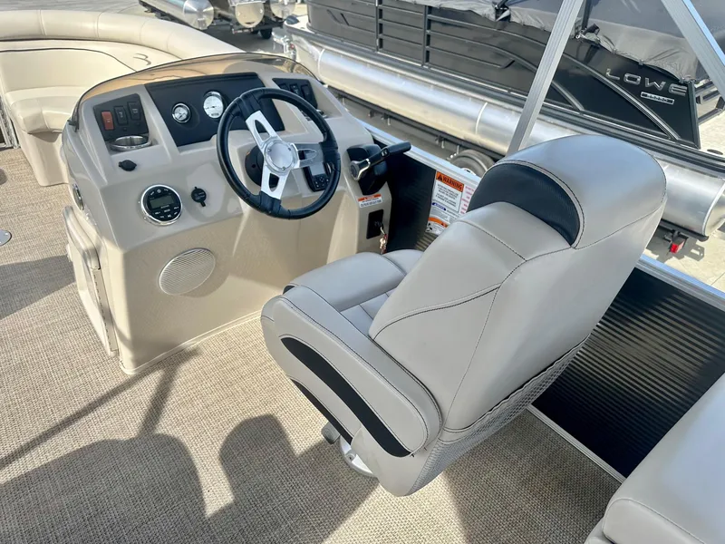 Slide: The Image of 2019 Bennington 22 SSX boat interior with steering wheel and captain's chair. - 6