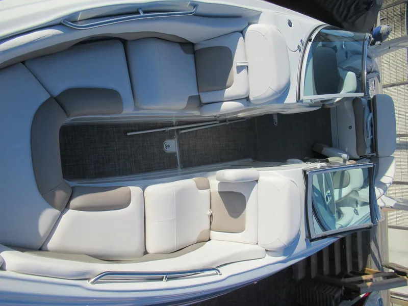 Slide: The Image of 2019 Crownline 285SS boat interior with white seating and open cockpit layout. - 11