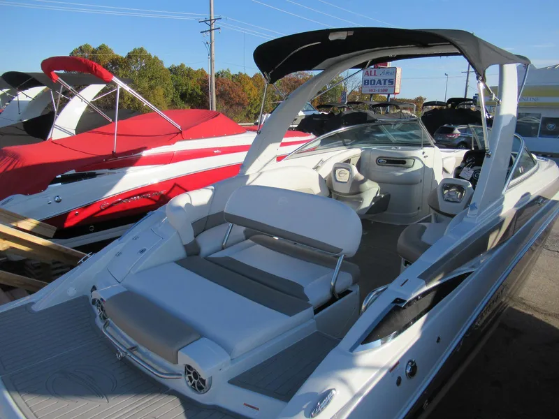 Slide: The Image of 2019 Crownline 285SS boat with sleek design and spacious seating, displayed outdoors. - 13