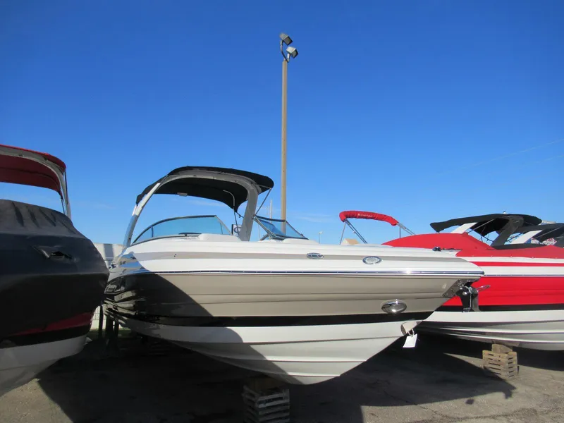 Slide: The Image of 2019 Crownline 285SS boat displayed outdoors under clear blue sky. - 16