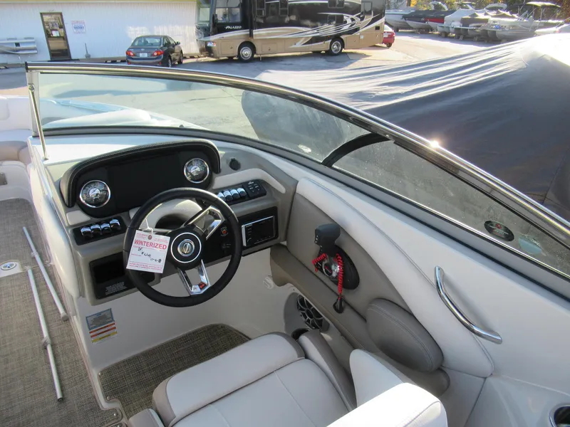 Slide: The Image of 2019 Crownline 285SS boat interior with steering wheel and dashboard controls. - 17