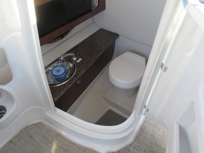 Slide: The Image of 2019 Crownline 285SS boat bathroom with sink and toilet. - 19