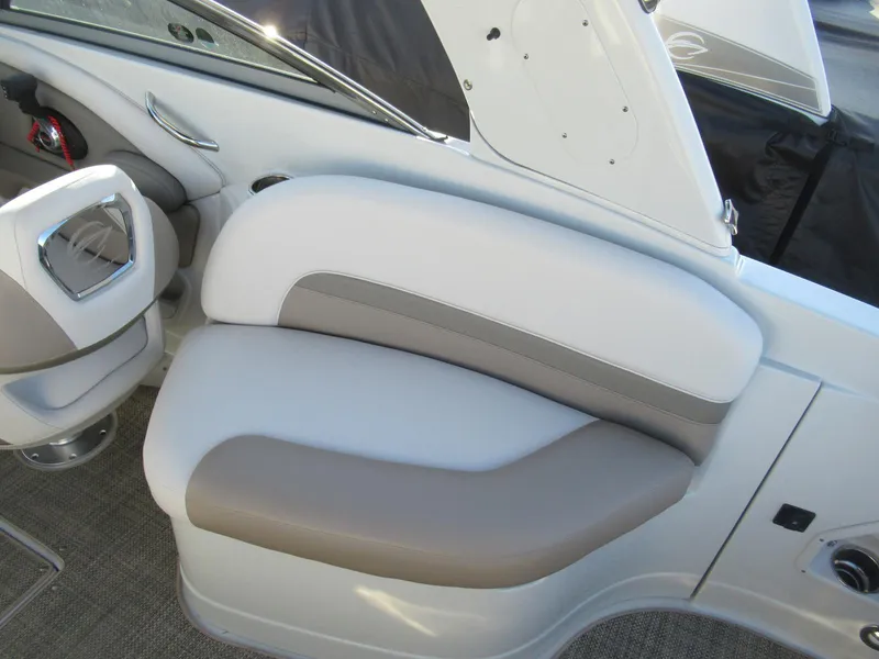Slide: The Image of 2019 Crownline 285SS boat interior seating with beige and white upholstery. - 23