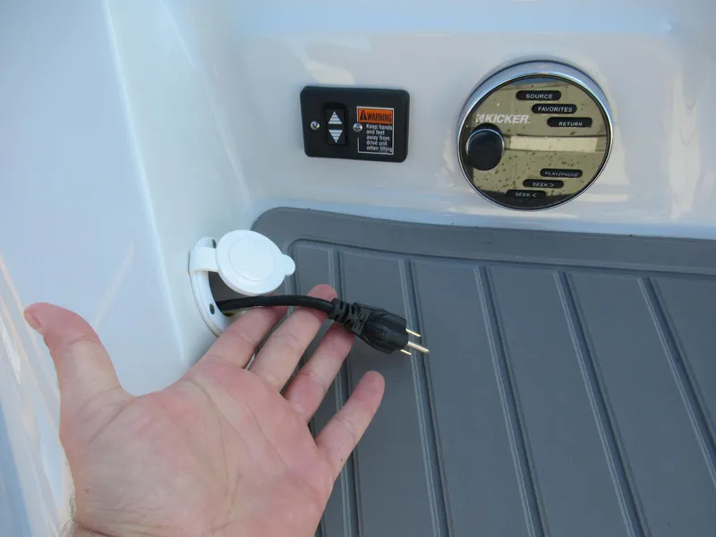 Slide: The Image of Crownline 285SS 2019 boat features power outlet and audio controls on deck. - 26