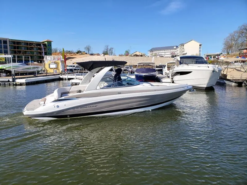 Slide: The Image of 2019 Crownline 285SS boat cruising in a marina under clear blue skies. - 4
