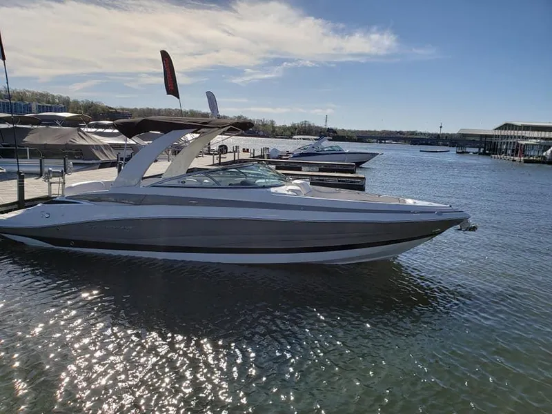 Slide: The Image of 2019 Crownline 285SS boat docked on a sunny day at a marina. - 6