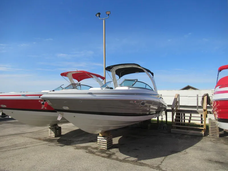 Slide: The Image of 2019 Crownline 285SS boat displayed on blocks under clear blue sky. - 7