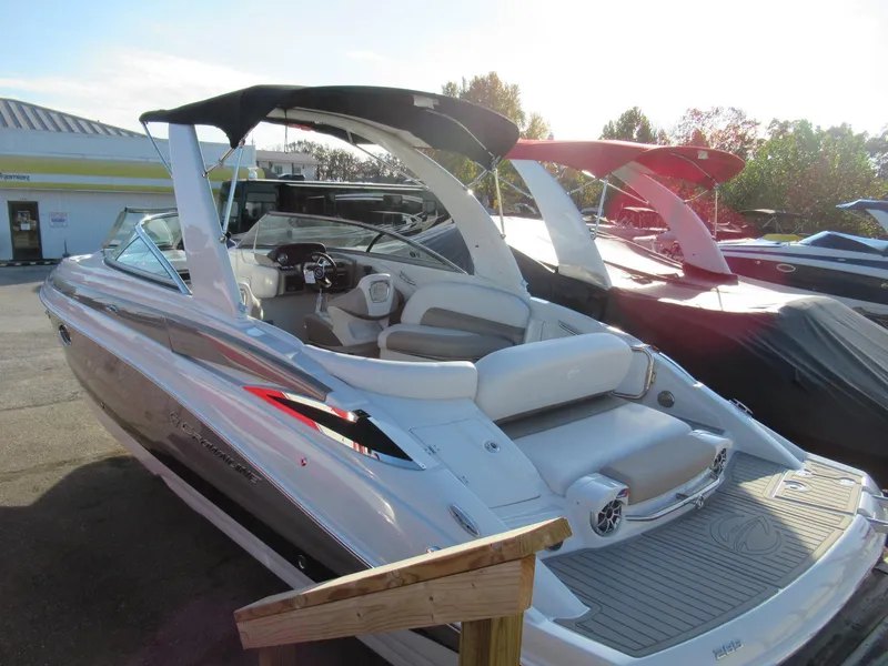 Slide: The Image of 2019 Crownline 285SS boat with sleek design and spacious seating, docked outdoors. - 8