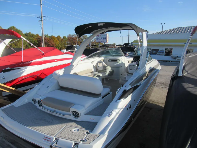 Slide: The Image of 2019 Crownline 285SS boat with sleek design and spacious interior at a dealership. - 9