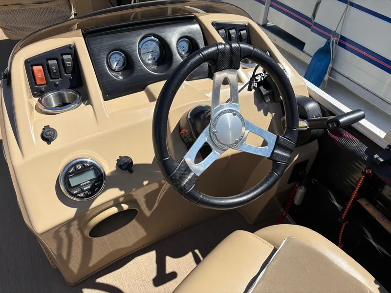 Slide: The Image of 2018 Bennington 21 SFX boat dashboard with steering wheel and control panel. - 10