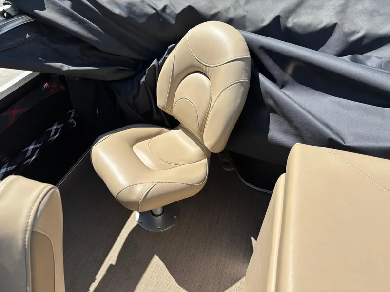Slide: The Image of Beige seat on 2018 Bennington 21 SFX boat, with black cover in background. - 11