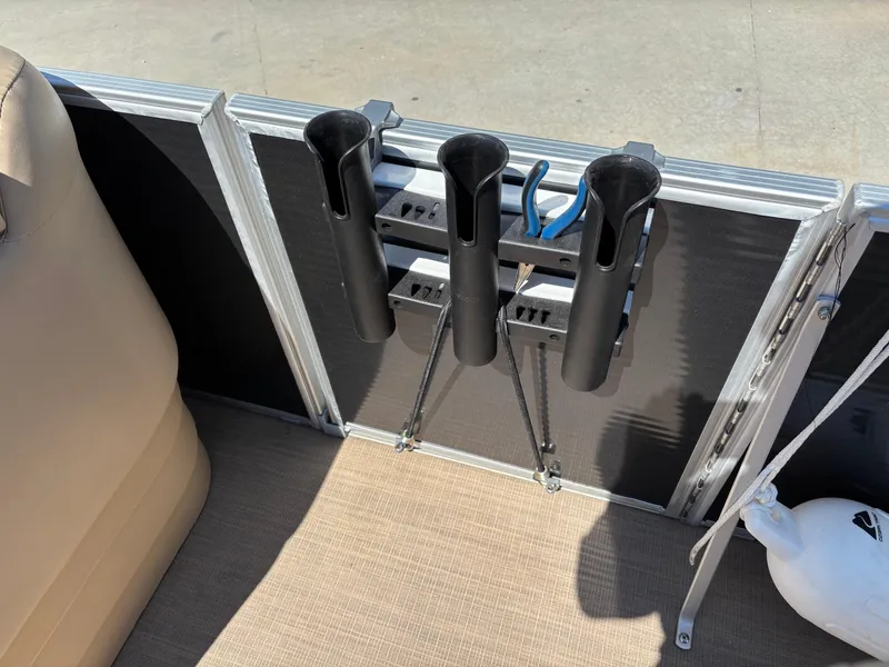 Slide: The Image of Rod holders on a 2018 Bennington 21 SFX boat deck, with beige seating and a white buoy. - 12