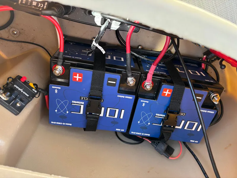 Slide: The Image of Batteries installed in a 2018 Bennington 21 SFX boat, featuring red and black cables. - 13