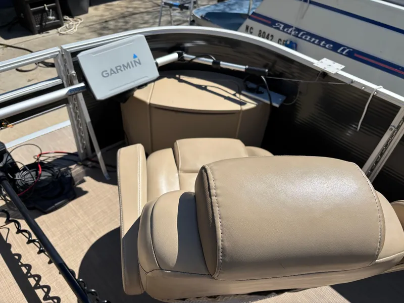 Slide: The Image of 2018 Bennington 21 SFX boat interior with Garmin device and beige seating. - 3