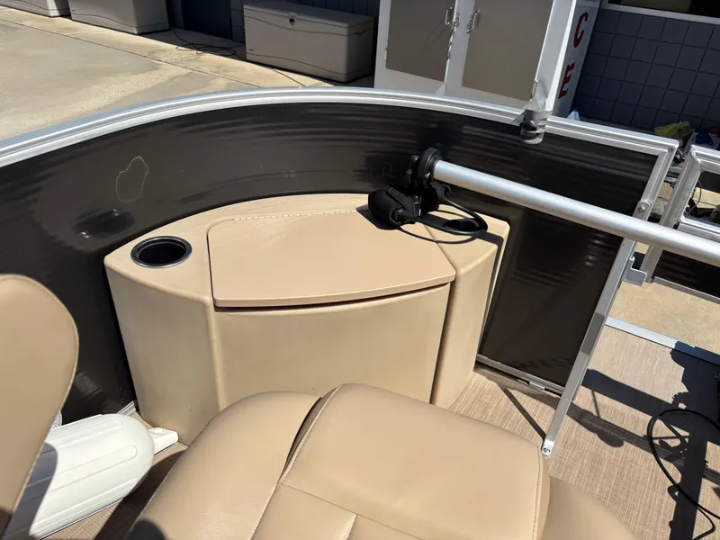 Slide: The Image of 2018 Bennington 21 SFX boat interior with beige seating and cup holder. - 6
